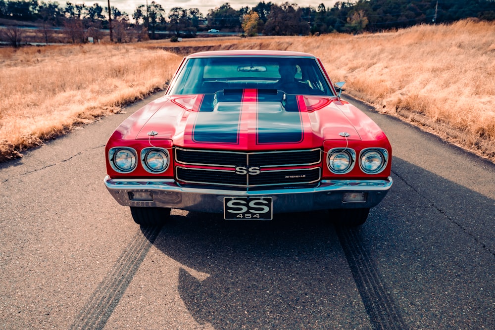 red chevrolet camaro on road during daytime