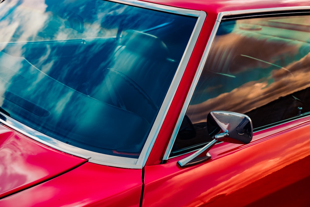 red car with white and blue sky