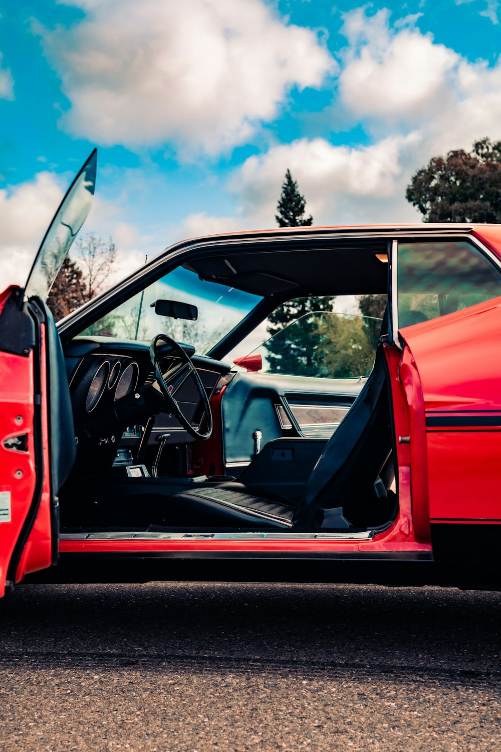 red and black car on road during daytime