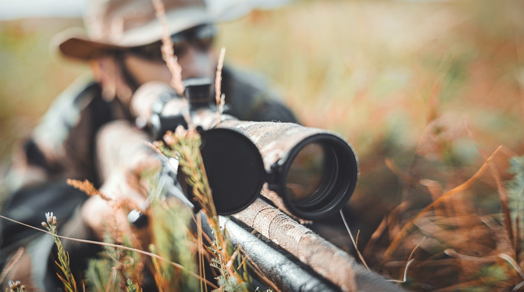 man looking through sniper scope