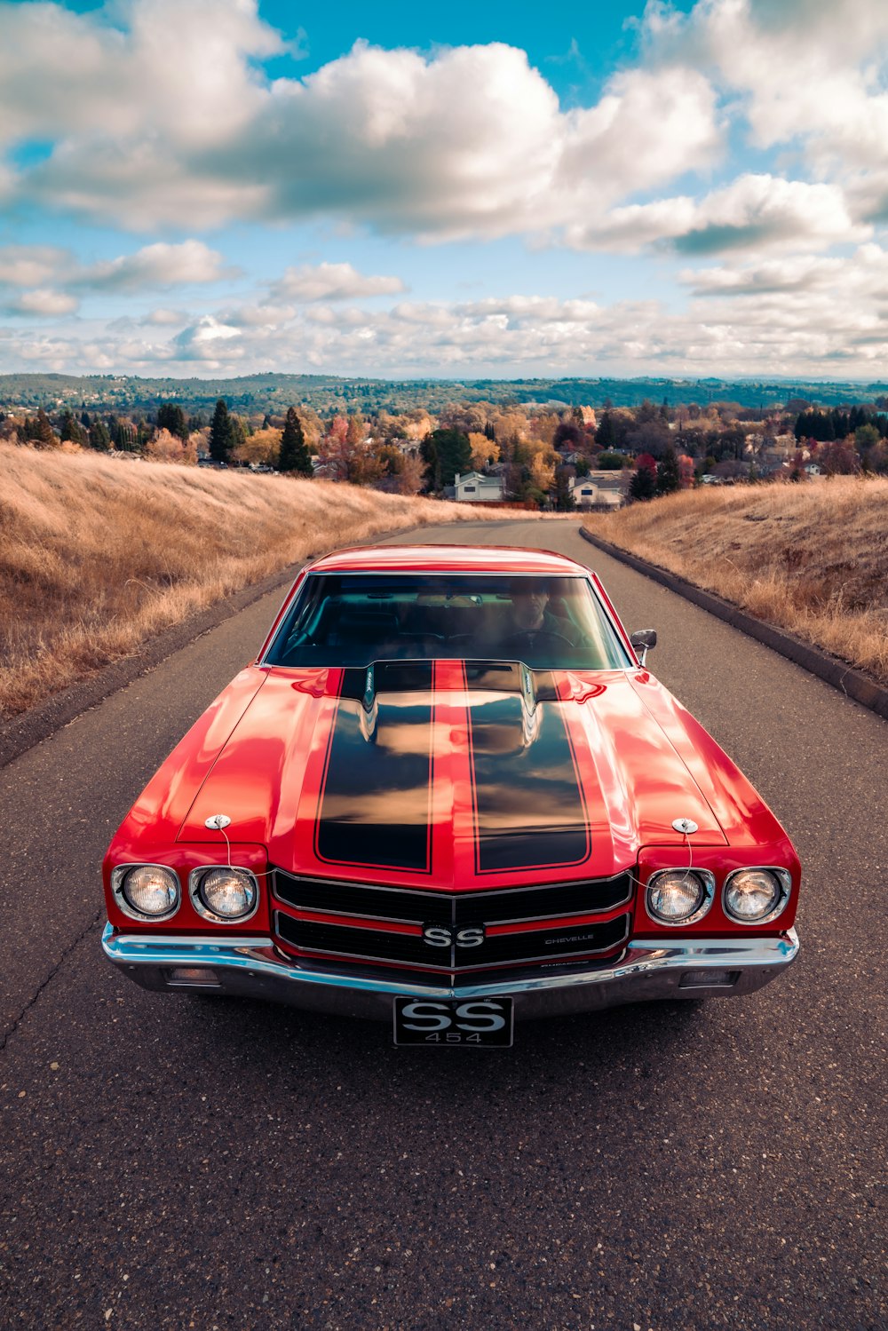 red chevrolet camaro on road during daytime