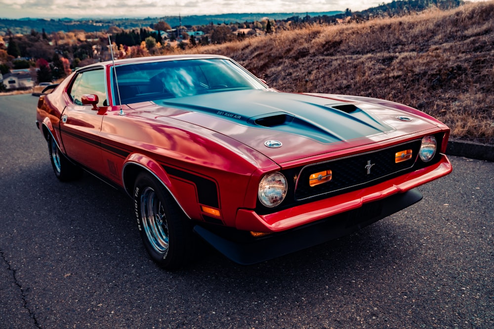 red and black chevrolet camaro on road during daytime