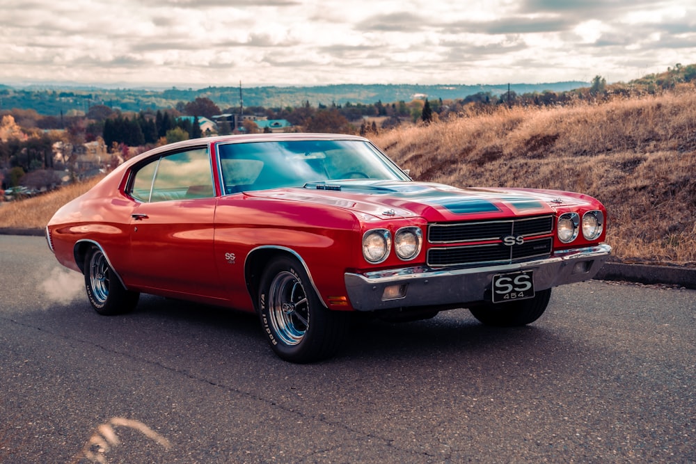 red chevrolet camaro on road during daytime