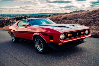 red chevrolet camaro on road during daytime
