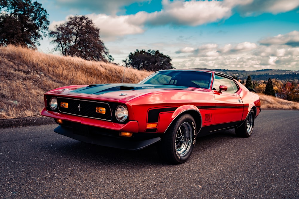 red chevrolet camaro on road during daytime