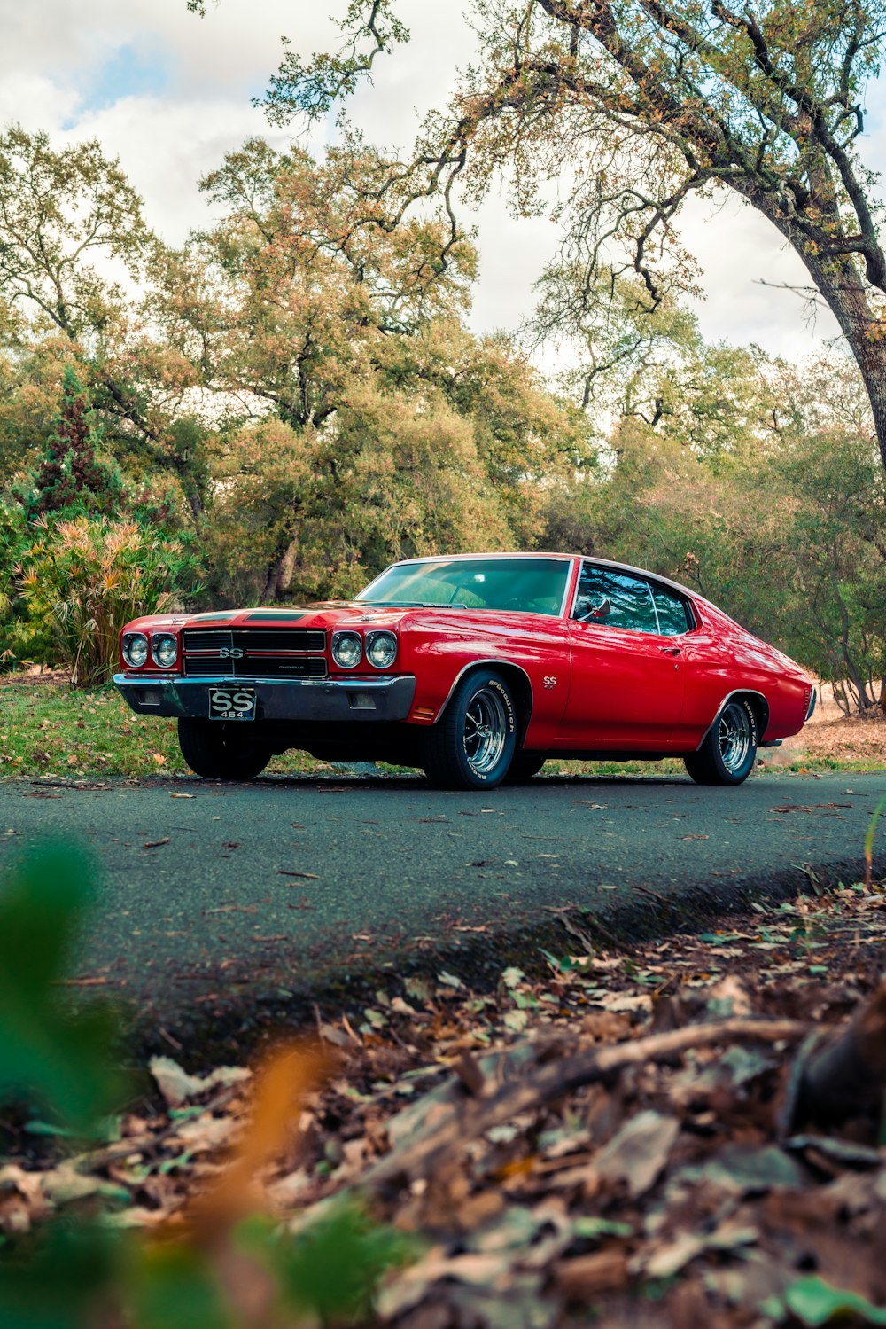 red chevrolet camaro on road during daytime