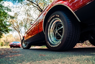 red car on gray asphalt road during daytime