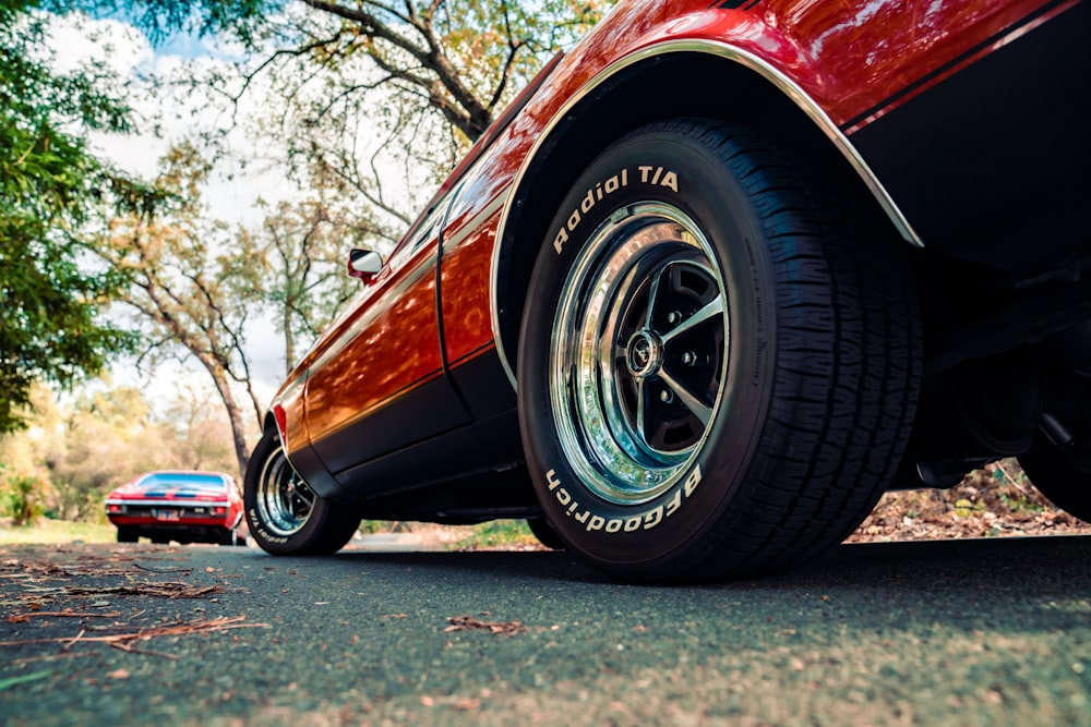 red car on gray asphalt road during daytime