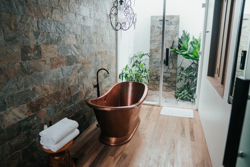 brown plastic bucket near white framed glass door