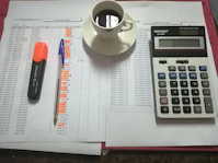 A calm workspace with a notebook, calculator, and coffee cup, symbolizing financial planning.