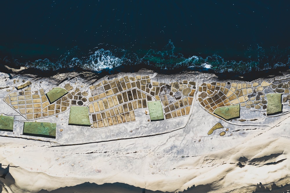 aerial view of ocean waves crashing on shore during daytime