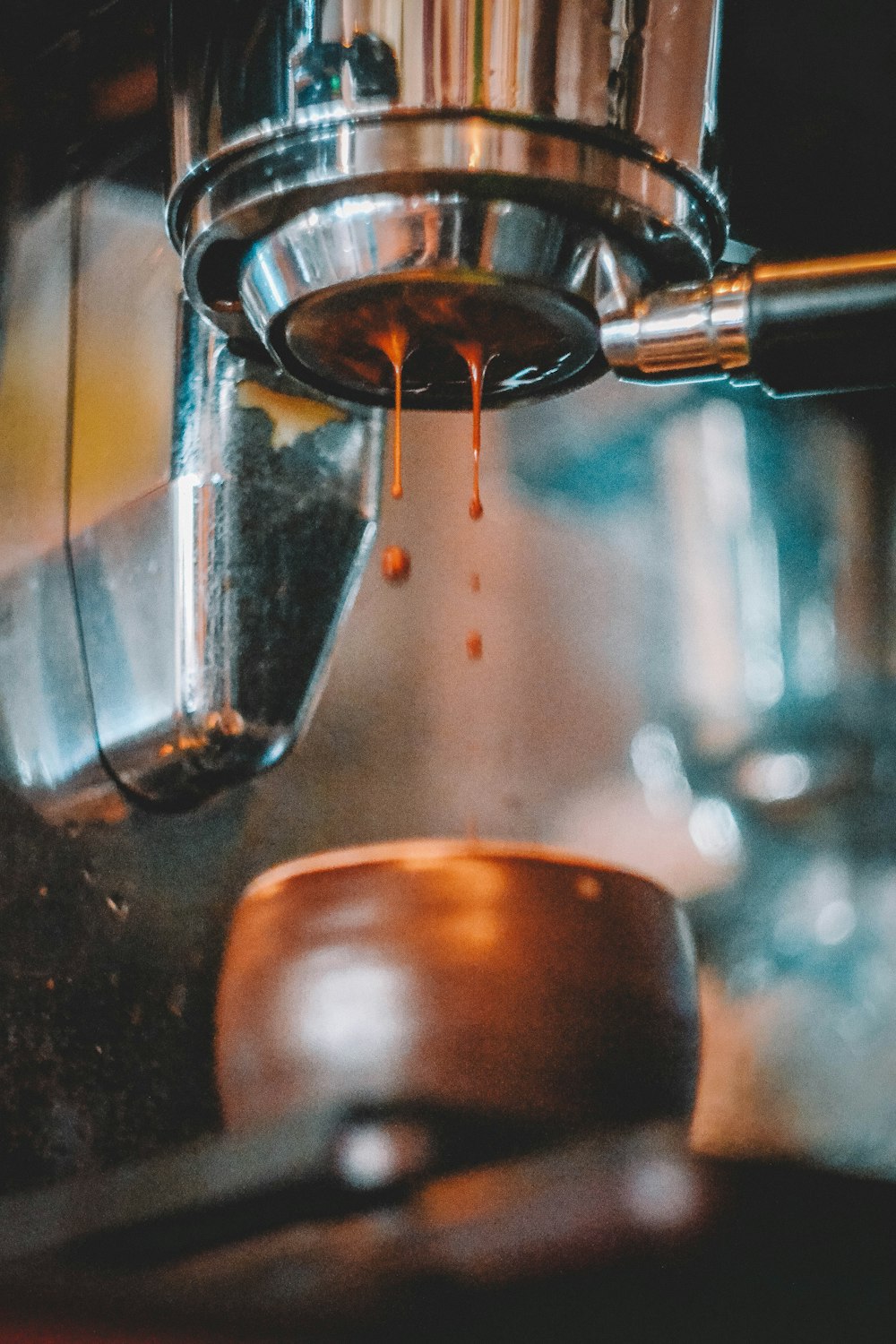 a coffee maker pouring coffee into a cup