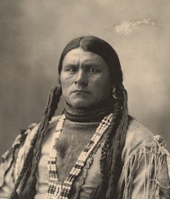 A serene portrait of a person wearing kimkemit, embodying strength and spiritual connection.