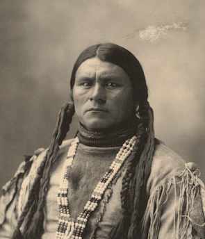 Portrait of Dalyon Shemil Benitez radiating calm strength, framed by deep earth tones and golden accents.