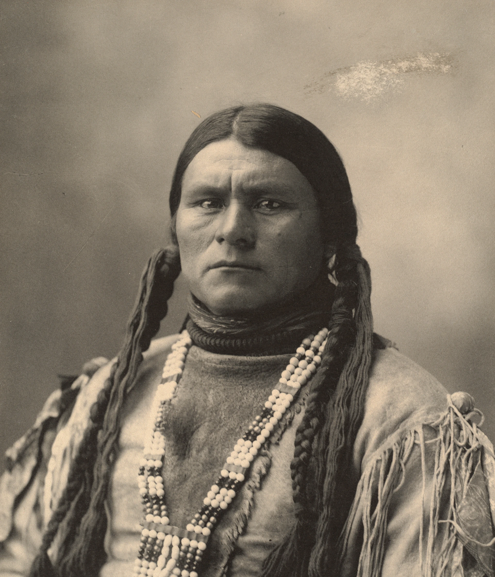 An artistic portrait of Aduke against a backdrop of deep browns and soft cream, her expression thoughtful and serene, embodying the blend of culture and storytelling.