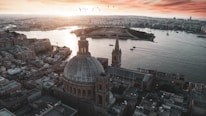 brown and white dome building near body of water during daytime