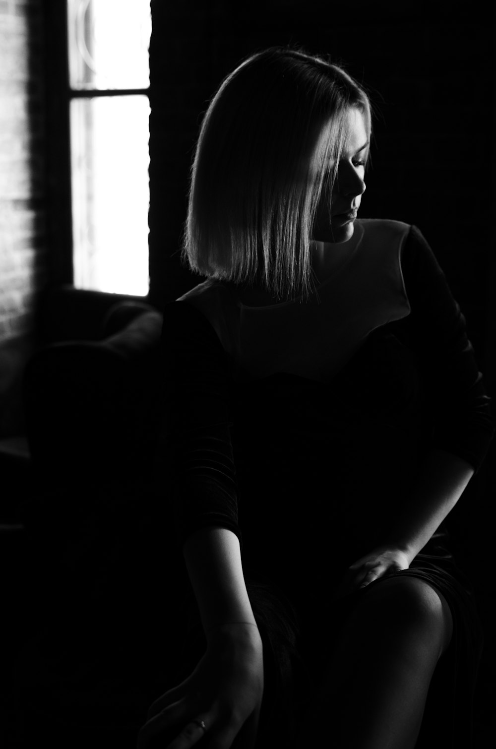 woman in black long sleeve shirt sitting on couch