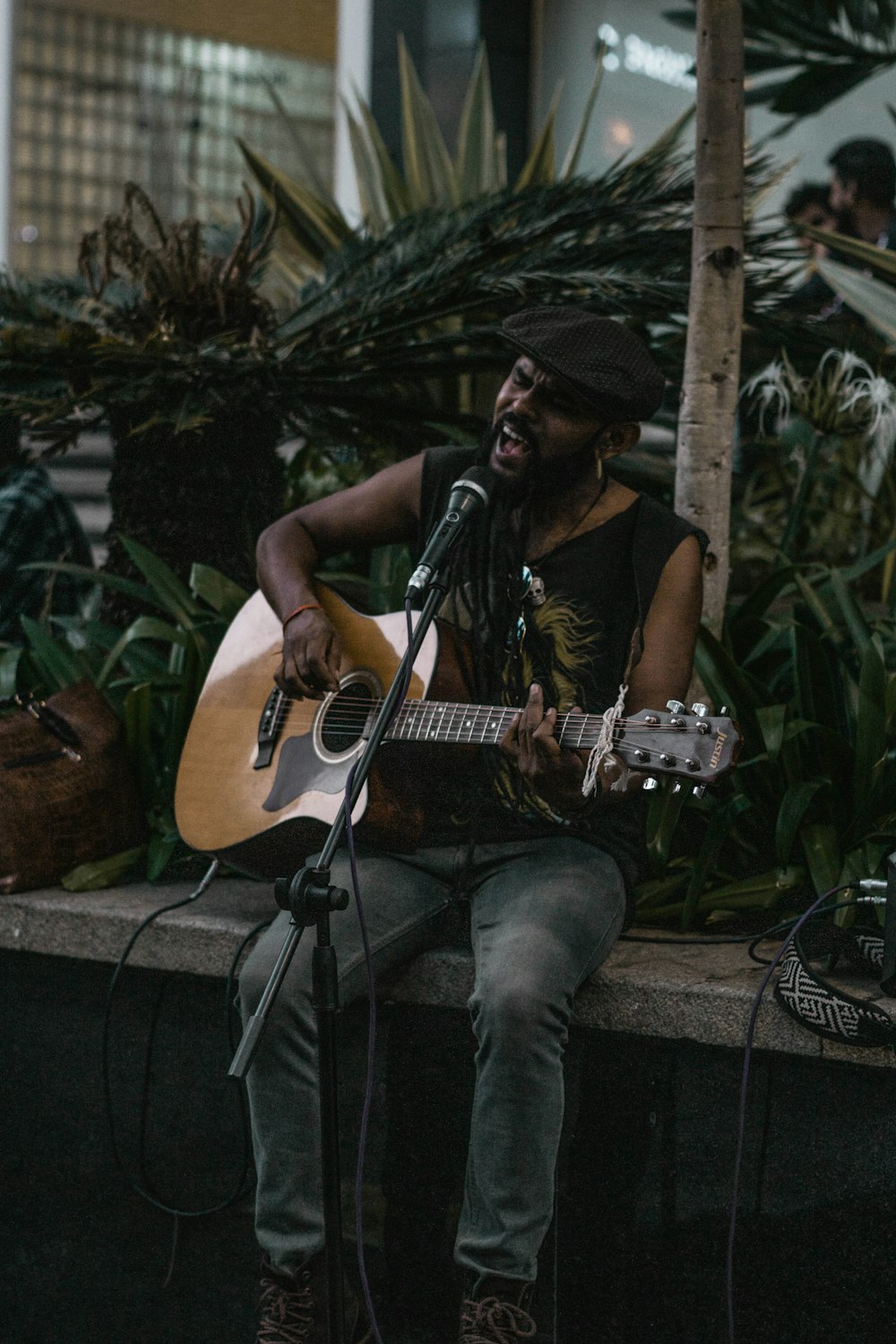 man in black shirt playing guitar