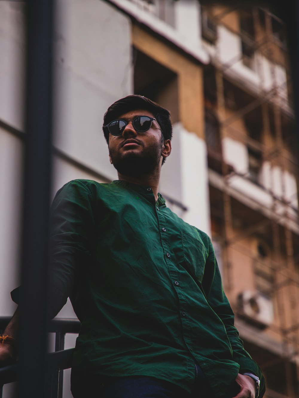 man in green long sleeve shirt wearing black sunglasses