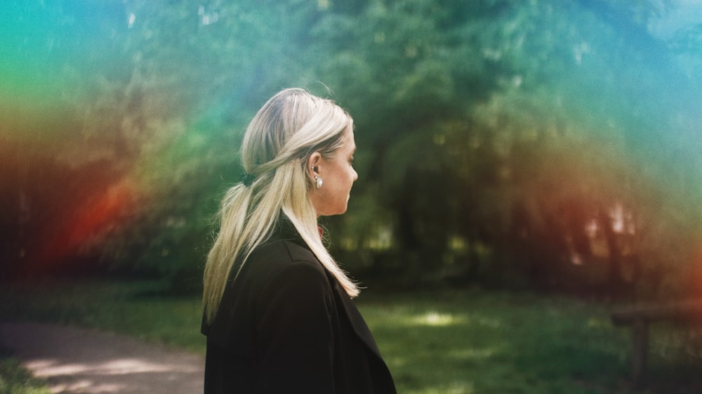 woman in black shirt standing on green grass field during daytime