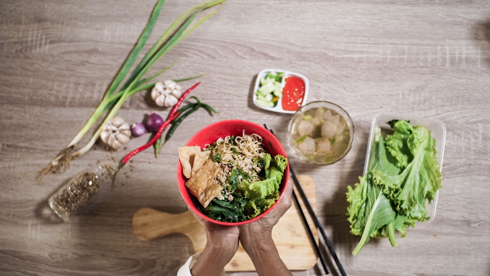 green and brown ceramic bowl with brown chopsticks