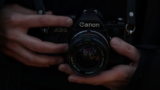 black nikon dslr camera on persons hand
