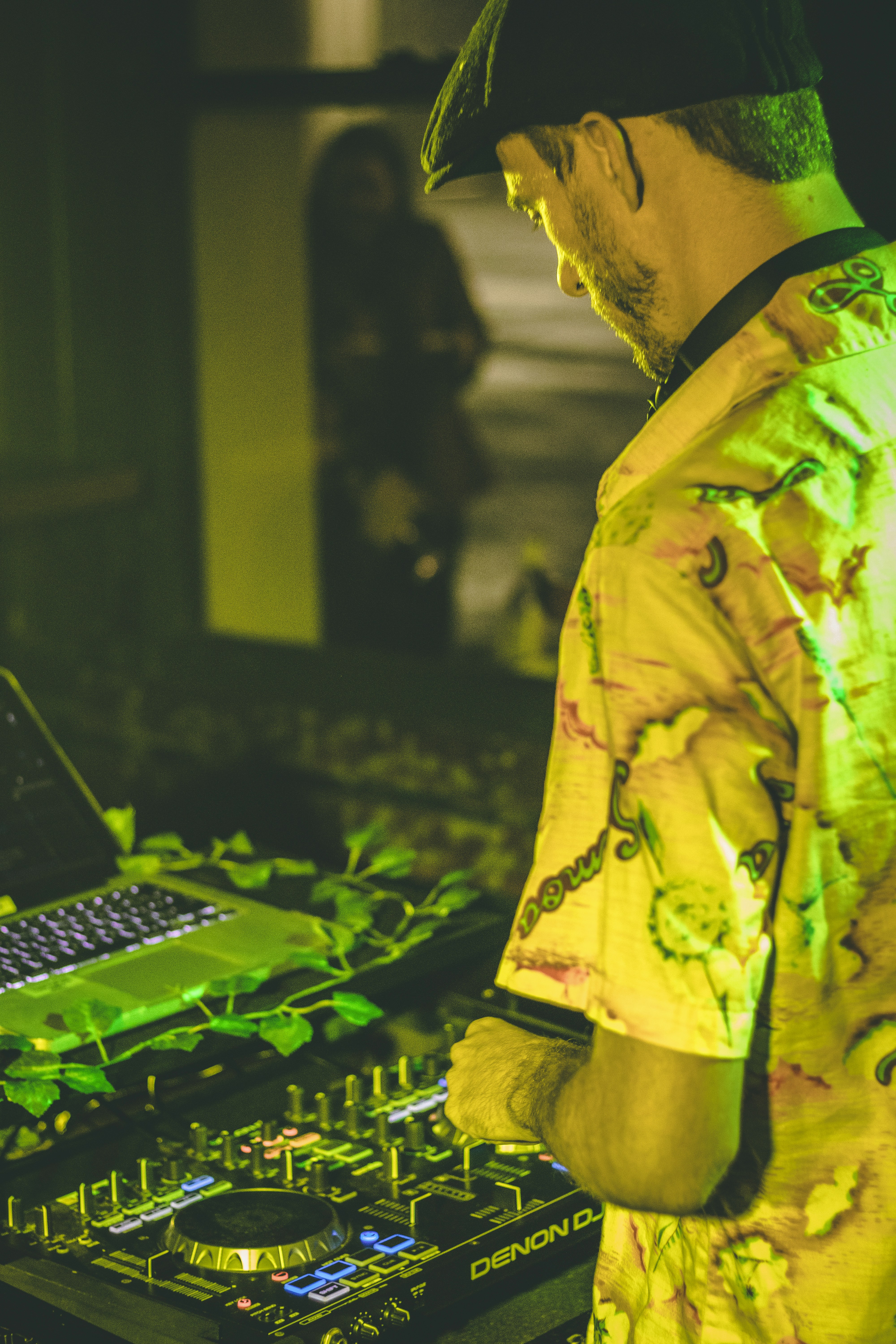 uomo in camicia abbottonata floreale gialla e verde usando il computer
