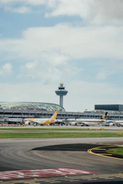 yellow and blue airplane on airport during daytime