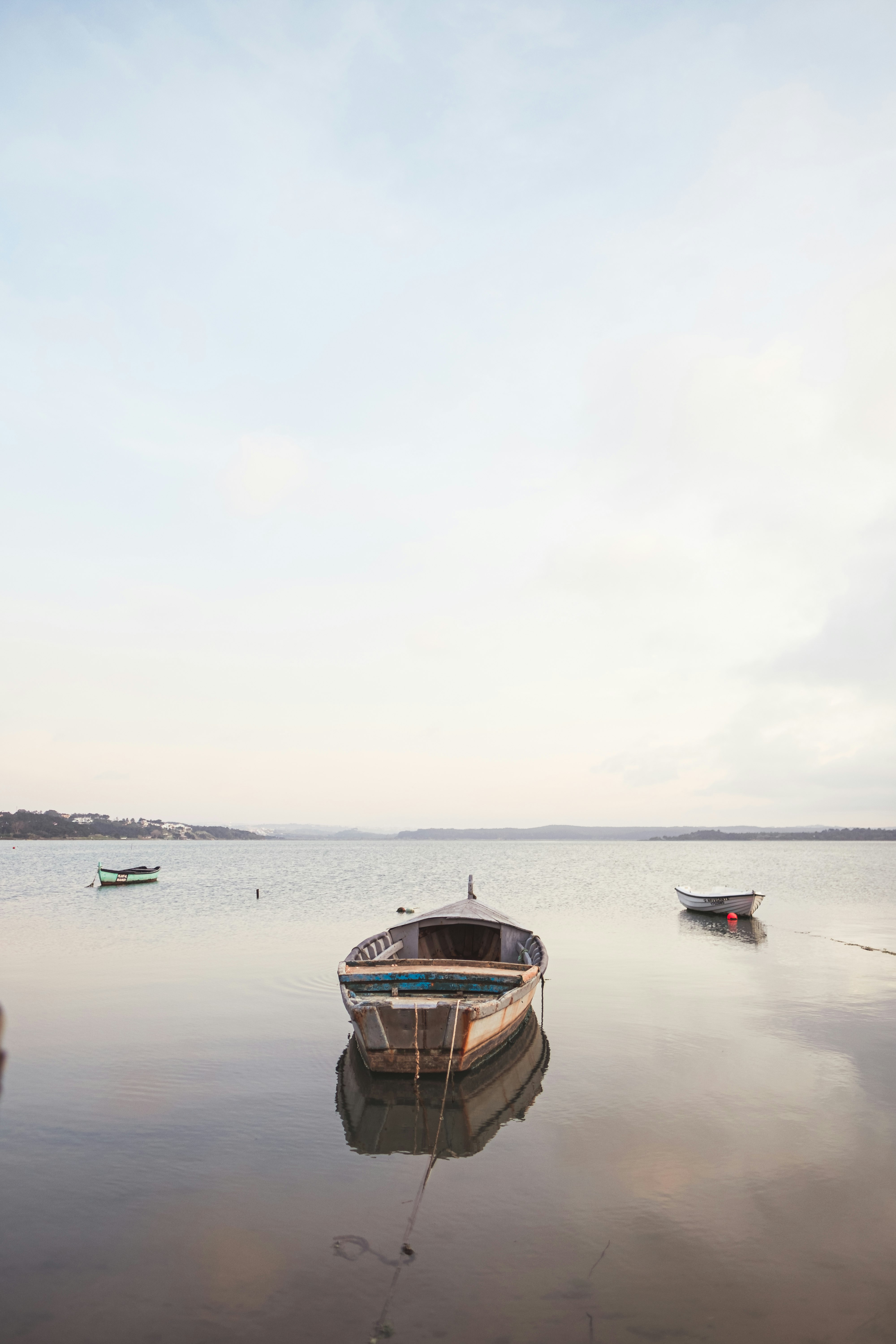 brown boat on sea under white sky during daytime