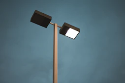 black and white street light under blue sky