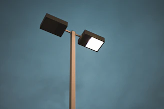black and white street light under blue sky