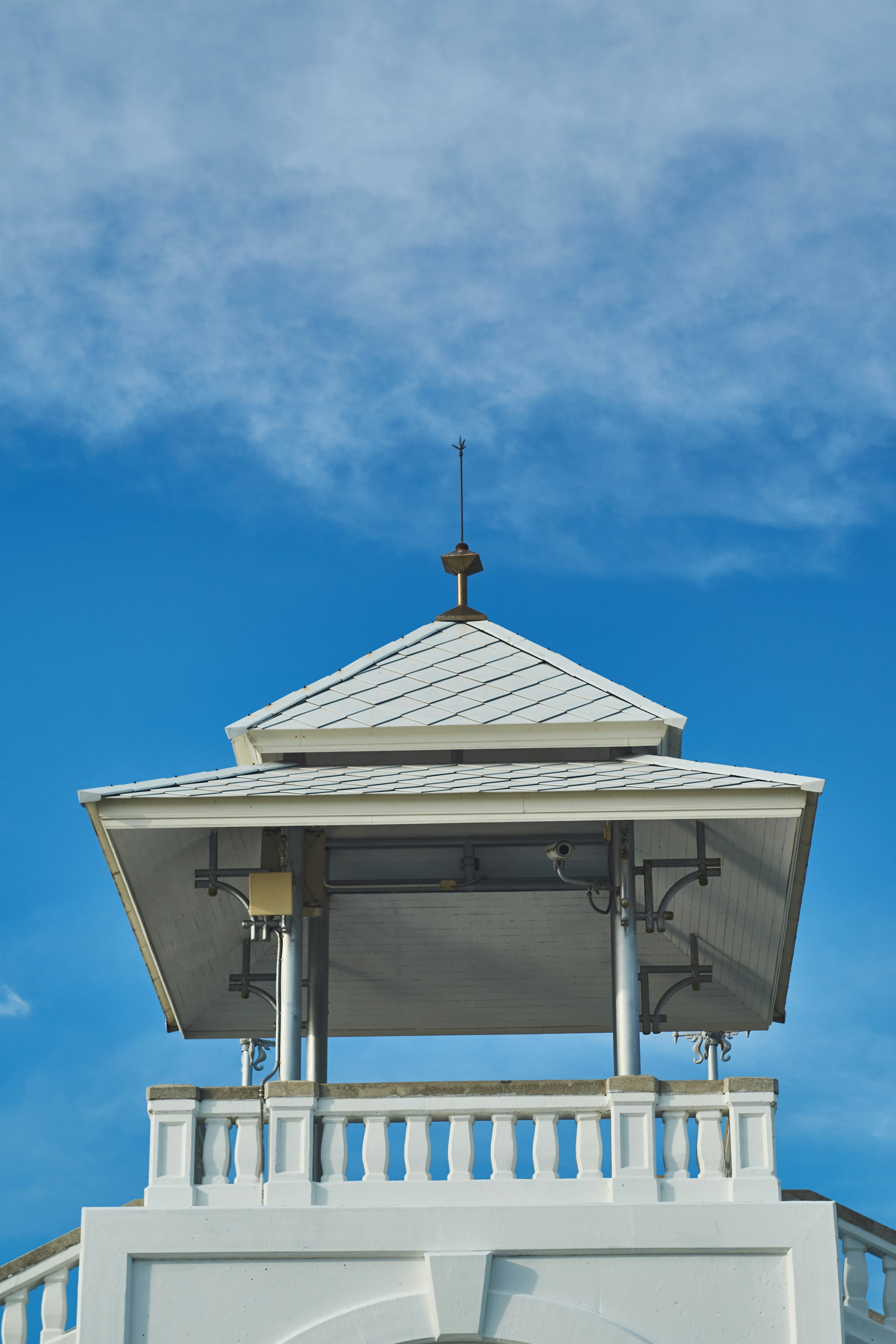 white and brown wooden gazebo under blue sky during daytime