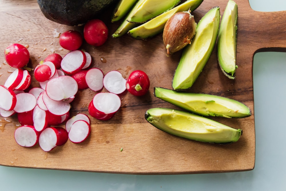 sliced cucumber and red tomato on brown wooden table