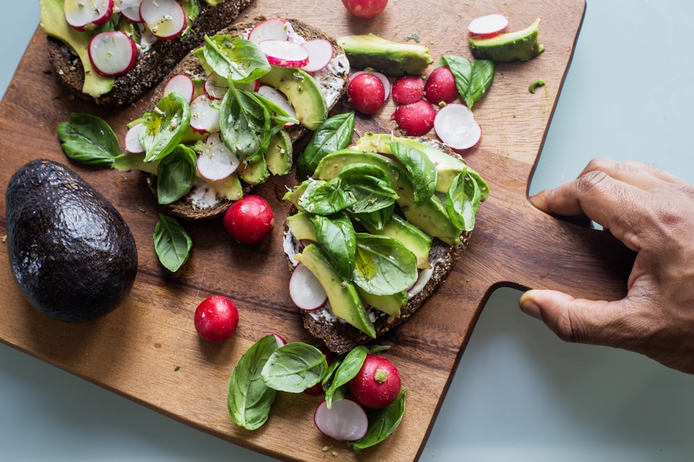 green and red vegetable on brown wooden chopping board