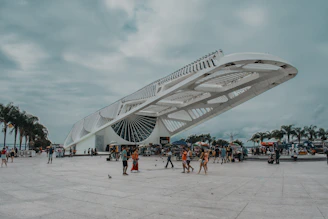 people walking on white sand near white building during daytime