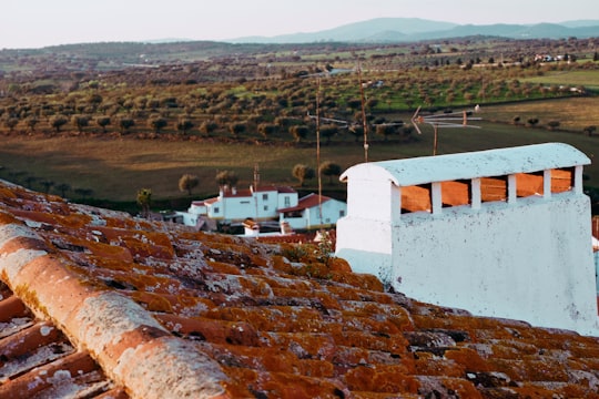 white concrete building on brown field during daytime in Arronches Portugal