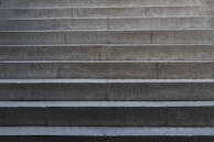 Custom residential concrete steps with a charcoal stain and sleek, minimalist design.