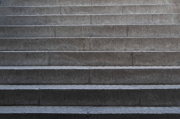 Finished concrete porch steps with a smooth surface and crisp corners in front of a home.