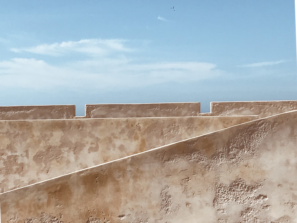 white concrete wall under blue sky during daytime