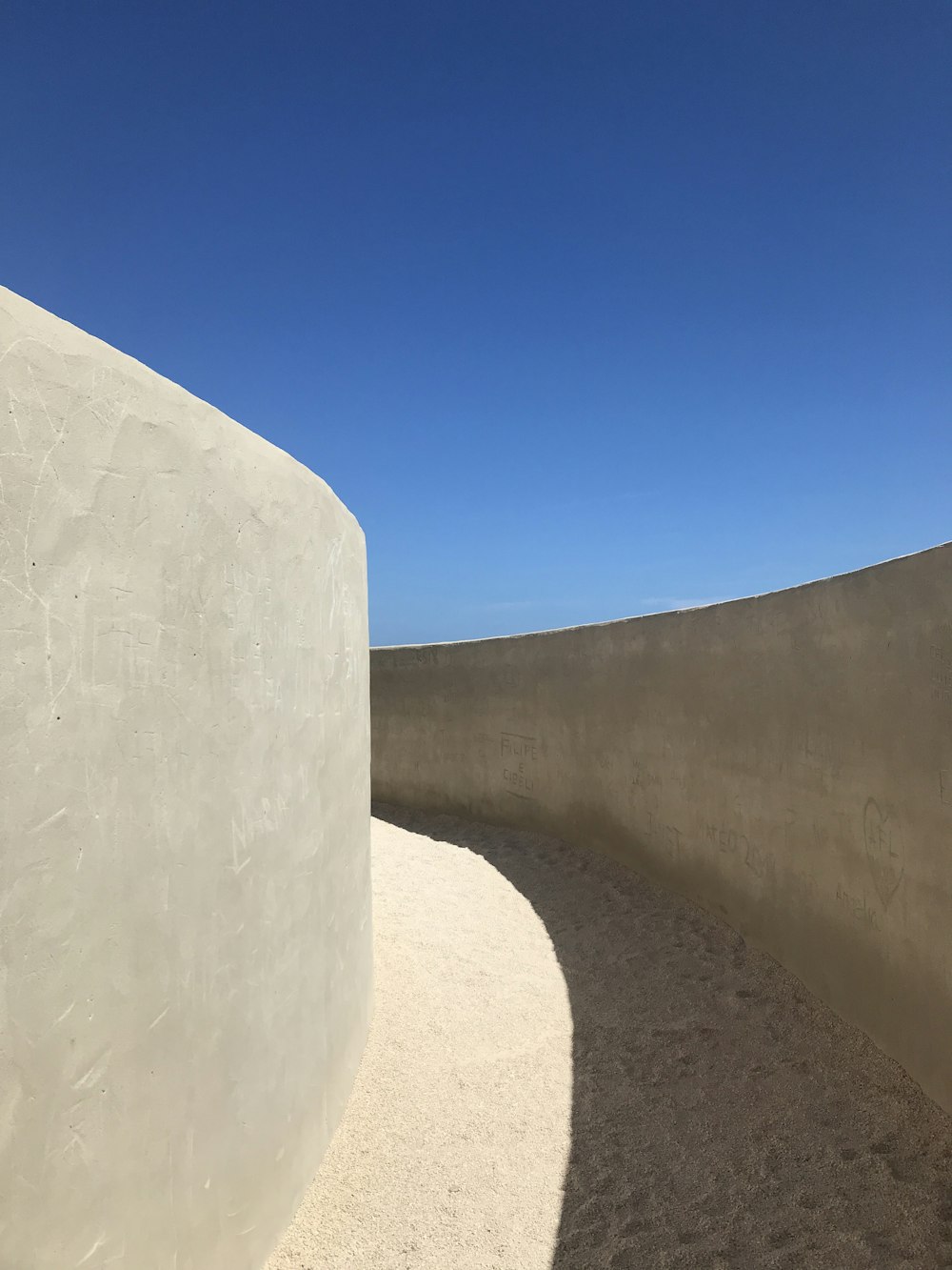 white concrete wall under blue sky during daytime