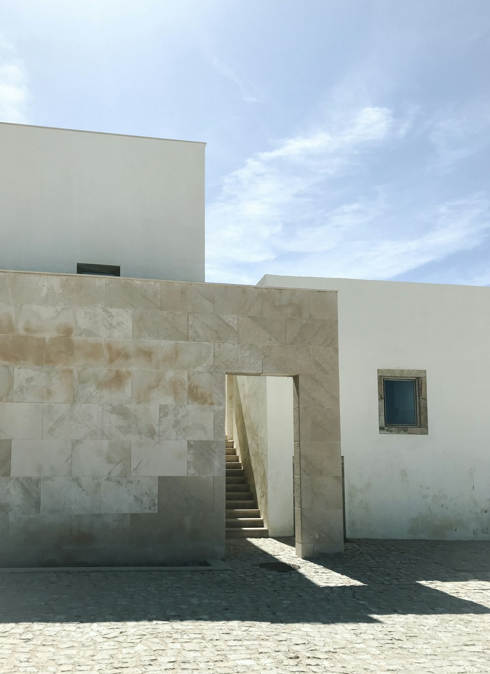 white concrete wall under blue sky during daytime