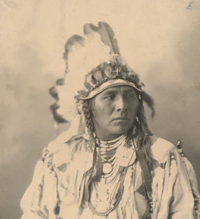 Kids wearing handmade Native American feather headdresses and face paint at a Wild West party.