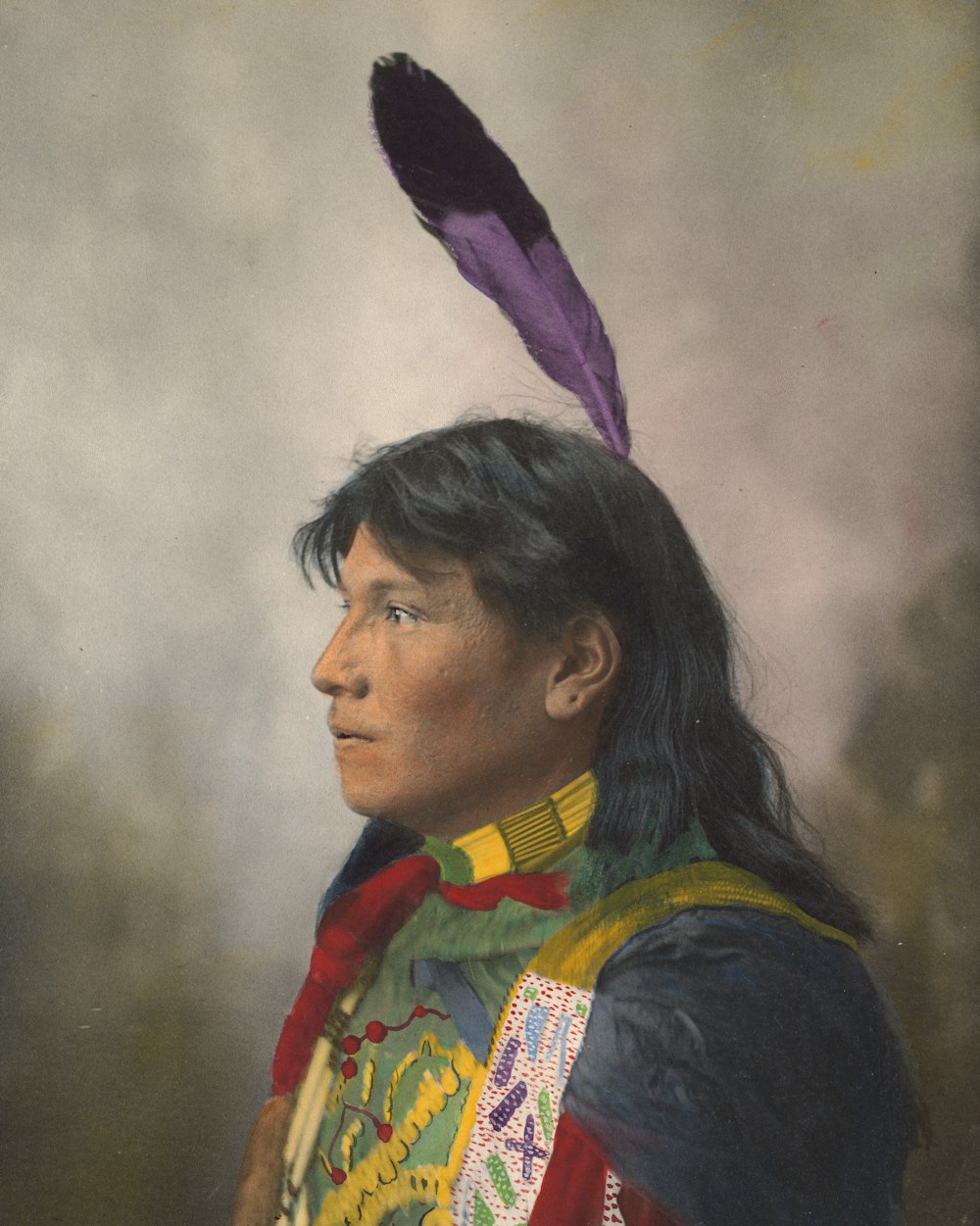 a native american man with a feather on his head