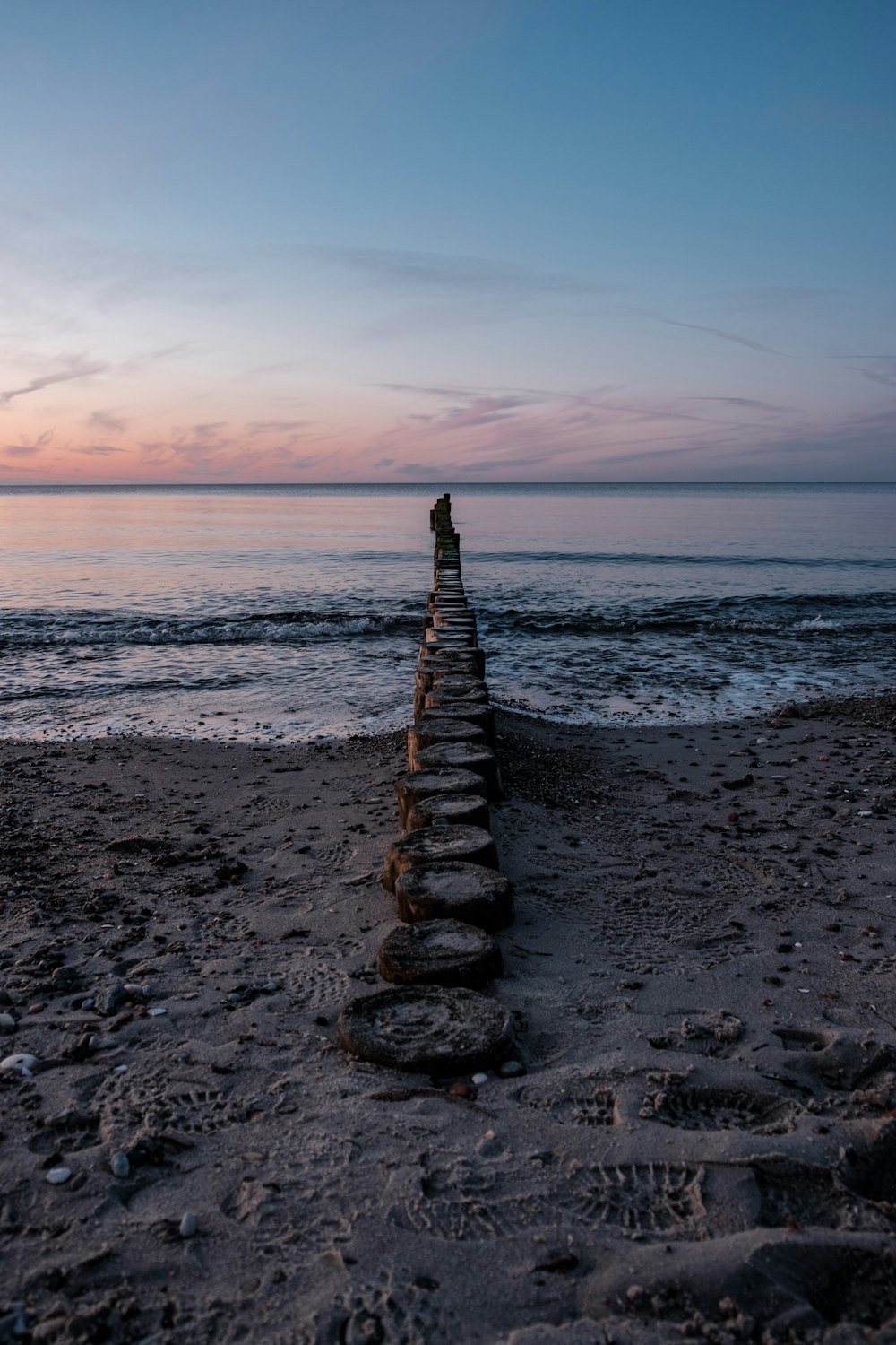 gray concrete stairs on beach during sunset