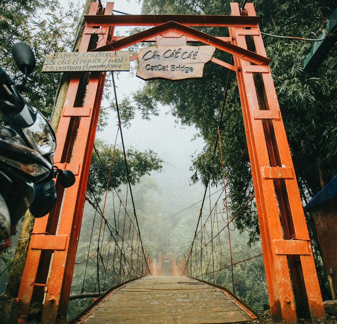 brown wooden hanging bridge over river during daytime