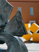 Close-up of a modern metal sculpture with geometric shapes and smooth metallic textures.
