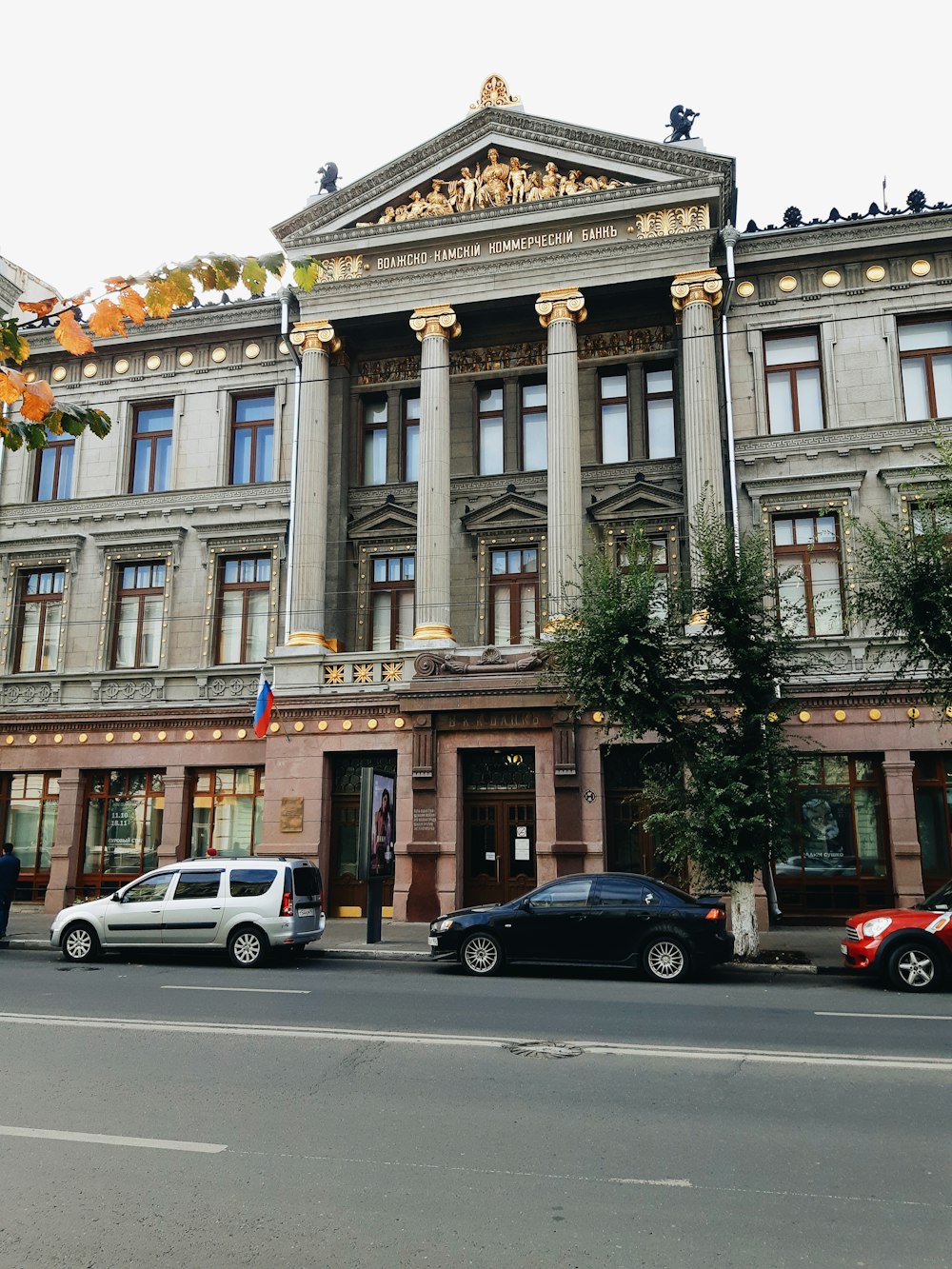 cars parked in front of brown building during daytime