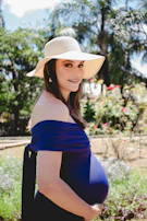 A model wearing a fashionable hat in an outdoor setting.