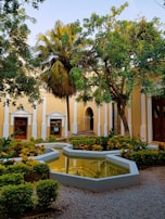 A peaceful courtyard combining natural stone, lush vegetation, and gentle water features.