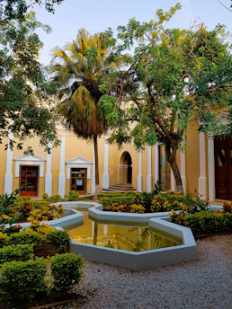 A peaceful residential condominium courtyard with lush greenery and comfortable seating areas.